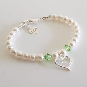 Peridot Pearl Heart Swarovski Crystal Bracelet Crafted using Swarovski Crystal White Pearls and peridot Crystals with Sterling Silver heard and clasp. Approximately 7.5" and can extend to 8".